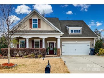 Charming two-story home with a well-manicured front yard, inviting curb appeal, and attached two car garage at 423 Castlebury Ct, Clover, SC 29710