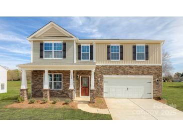 Charming two-story home with stone accents, attached garage, and manicured lawn at 8073 Kennesaw Dr, Gastonia, NC 28056