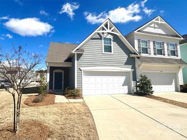 Charming two-story home with a well-maintained lawn and two car garage on a beautiful sunny day at 8573 River Ridge Dr, Charlotte, NC 28213