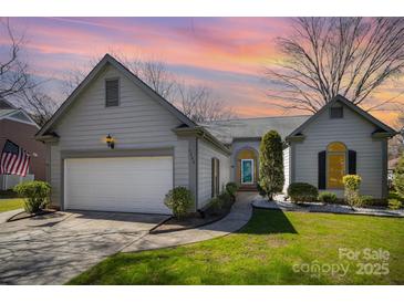 Charming home with a well-manicured lawn, two car garage, and welcoming curb appeal at 9200 Four Acre Ct, Charlotte, NC 28210