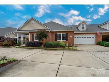 Brick home with a two-car garage and lovely landscaping at 2227 Cashmere Ct, Denver, NC 28037