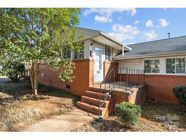 Charming brick home with a welcoming front door and well-maintained landscaping at 3120 Minnesota Rd, Charlotte, NC 28208