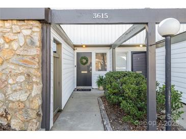 Inviting front entrance featuring a black front door, stone wall accents, and well-maintained landscaping at 3615 Maple Glenn Ln, Charlotte, NC 28226