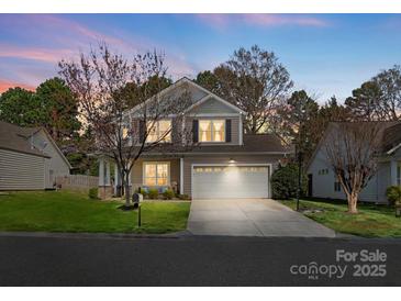 Charming two-story home with attached two-car garage, manicured lawn, and inviting curb appeal at 421 Silver Cypress Ln, Fort Mill, SC 29708