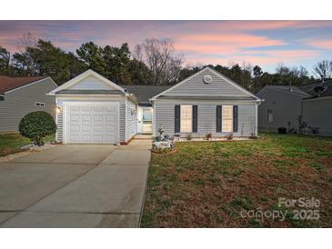 Charming home featuring a manicured lawn, covered entryway, and attached one car garage at 7918 Travers Run Dr, Charlotte, NC 28215