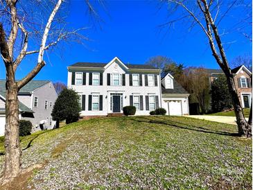 Charming two-story home featuring a classic white exterior with black shutters and attached garage at 9146 Austin Ridge Ln, Charlotte, NC 28214