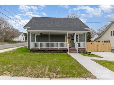 Charming home with a welcoming front porch and well-maintained lawn at 102 S Liberty St, Gastonia, NC 28052