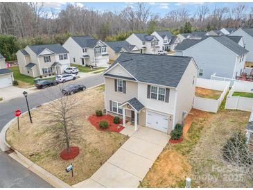 Charming two-story home with manicured lawn, freshly mulched beds, and a paved driveway at 1301 Waylon Ave, Gastonia, NC 28054
