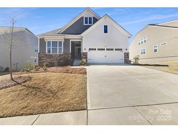 Charming two-story home with well-maintained landscaping and a spacious driveway on a sunny day at 15633 Aviary Orchard Way, Charlotte, NC 28278