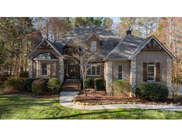 Charming brick home with stone accents, mature landscaping, and a welcoming entrance with a brick stairway at 2379 Metcalf Dr, Sherrills Ford, NC 28673