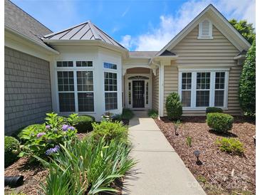 Charming single-story home with landscaped front yard and inviting entrance featuring large windows at 36112 Watsonia St, Fort Mill, SC 29707