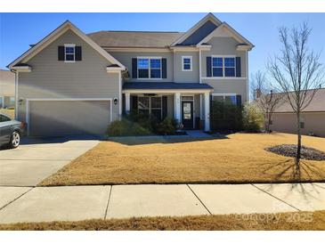 Charming two-story home with well-manicured lawn, inviting porch, and a two-car garage, perfect for families at 858 Oak Manor Se Dr, Concord, NC 28025