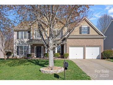 Traditional two-story home featuring a two-car garage, front lawn, and neutral-tone facade at 114 Runningdeer Dr, Mooresville, NC 28117