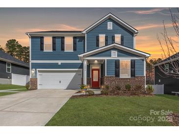 Charming two-story home featuring blue siding, black shutters, a red door, and an attached two-car garage at 12234 Rowan Hill Dr, Huntersville, NC 28078