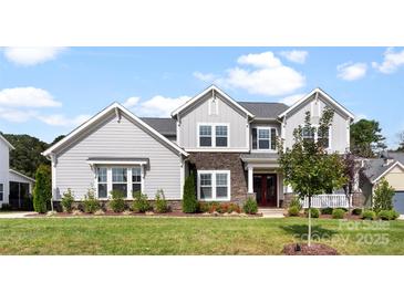 Beautiful two-story home featuring a manicured lawn and a charming front entrance at 13108 Brooklyn Skylar Way, Huntersville, NC 28078