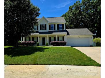 Charming two-story home with black shutters, manicured lawn, and attached two car garage at 14922 Rolling Sky Dr, Charlotte, NC 28273