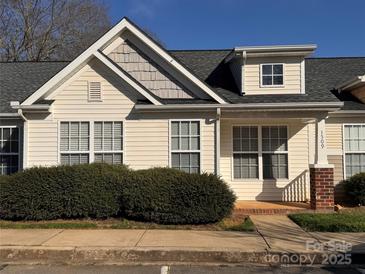 Charming home with light siding, detailed roofing, manicured bushes and inviting front porch at 1509 Tiana Way, Rock Hill, SC 29732