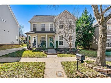 Charming two-story home featuring a welcoming front porch, landscaped yard and classic architectural details at 17847 Caldwell Track Dr, Cornelius, NC 28031