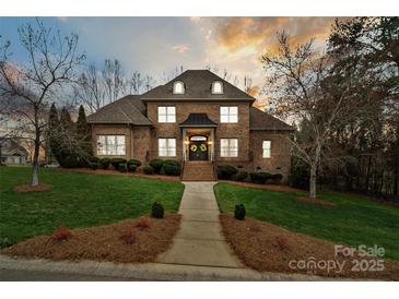 Gorgeous brick home with manicured lawn and inviting entryway at sunset at 1838 Landry Ln, Rock Hill, SC 29732