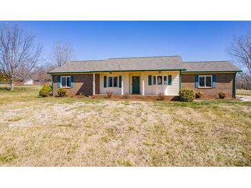 Charming ranch home featuring a brick and vinyl exterior with lush landscaping at 19 Harolds Ct, Taylorsville, NC 28681