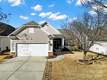 Charming home with a two-car garage, beautiful landscaping, and an inviting entrance at 2018 Links View Dr, Fort Mill, SC 29707