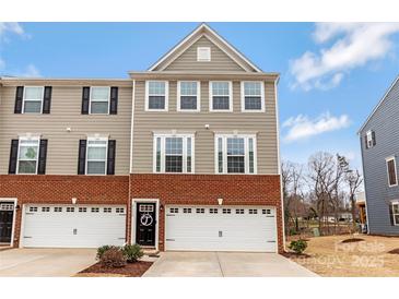 Charming three-story townhome features a brick facade, two-car garage, and inviting front entrance at 2175 Autumn Cyprus Ave, Gastonia, NC 28054