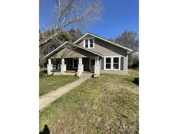 Charming home featuring a welcoming front porch with classic architectural details at 222 2Nd Ave, Albemarle, NC 28001