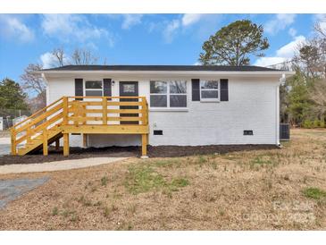 Charming white brick home with a new wooden porch and black shutters at 356 Hill Rd, Lincolnton, NC 28092