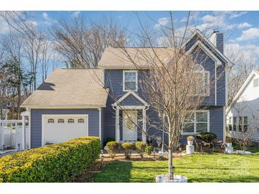 Charming two-story home with blue siding, manicured lawn, and attached garage in a desirable neighborhood at 3601 Rosedown Dr, Matthews, NC 28105