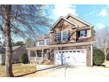 Inviting two-story brick home featuring a two-car garage and a charming covered front porch at 4119 Flint Dr, Lancaster, SC 29720