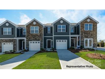 New townhomes with stone accents, attached garages and manicured lawns at 529 Trading Post Ln, York, SC 29745