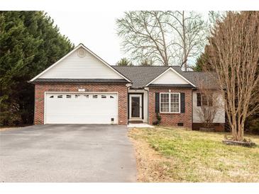 Charming single-story brick home with attached garage and well-maintained front lawn in a quiet neighborhood at 103 Pine Meadows Cir, Hickory, NC 28601