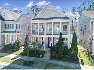 Charming two-story home with a double porch, green lawn, and inviting curb appeal at 124 Helton Ln, Fort Mill, SC 29708