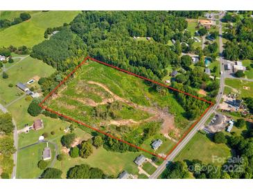 This aerial view showcases a large lot, framed by lush trees and bordered by a quiet road at 1414 S Post Rd, Shelby, NC 28152