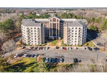 Attractive multi-story apartment building with balconies and plenty of parking in a wooded area at 211 Heritage Blvd # 612, Fort Mill, SC 29715