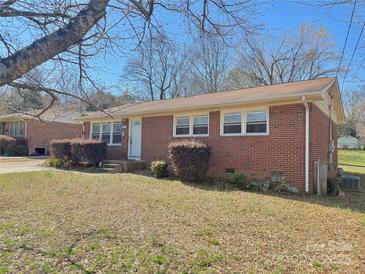 Charming brick home featuring manicured shrubs, a well-kept lawn, and a classic facade at 2210 Milton Rd, Charlotte, NC 28215