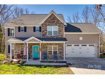 Charming two-story home featuring a stone facade, inviting front porch, and a two-car garage at 2375 Ellison Cir, Lancaster, SC 29720