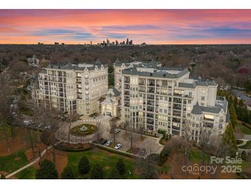 Beautiful high-rise condo complex with balconies and city views at sunset at 2823 Providence Rd # 156, Charlotte, NC 28211