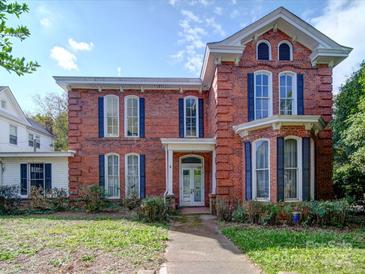 Beautiful brick two-story home with symmetrical design and welcoming front entrance at 303 Wade St, Wadesboro, NC 28170