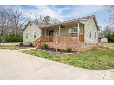 Charming home featuring a cozy porch, wooden railing, and manicured landscaping at 3155 Ramseur St, Lincolnton, NC 28092