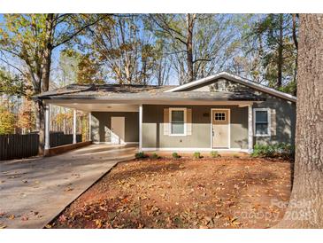 Charming single-story home with a covered carport, a front yard covered in leaves, and autumn foliage at 325 Spring Oak Dr, Salisbury, NC 28147