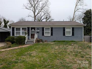 Charming single-story home with a brick facade, well-kept lawn, and inviting front entrance at 4408 Pebblebrook Dr, Charlotte, NC 28208