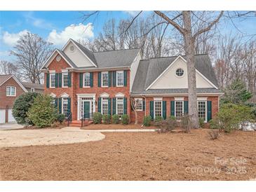 Charming two-story brick home featuring a landscaped front yard and traditional architectural details at 4918 Sarah Hall Ln, Charlotte, NC 28270