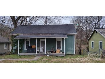 Quaint single-story home with a covered front porch and an overgrown lawn, ready for renovation at 525 S Trenton St, Gastonia, NC 28052