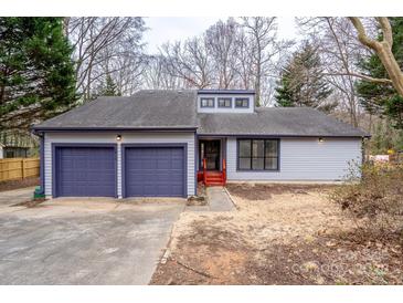 Charming single-story home featuring a two-car garage, blue trim, and well-maintained landscaping at 6415 Santa Cruz Trl # 11, Charlotte, NC 28227