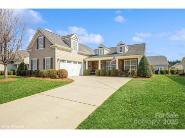 Charming home with a manicured lawn, stone accents, and a welcoming front porch, perfect for enjoying the outdoors at 8633 Sequoia Grove Ln, Charlotte, NC 28214