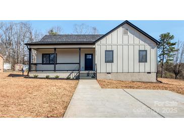 Charming single-story home with a welcoming front porch and modern design elements at 1313 Springdale Park Dr, Lincolnton, NC 28092