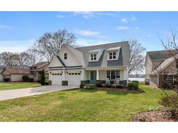Charming two-story home featuring a three-car garage and inviting front porch at 20601 Island Forest Dr, Cornelius, NC 28031
