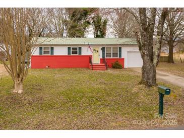 Charming single-story home with red brick foundation, yellow door, and well-maintained lawn at 2577 Kingston St, Newton, NC 28658