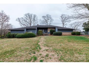 Charming single-story home with a well-manicured front yard and mature landscaping at 404 Downing Dr, Kings Mountain, NC 28086
